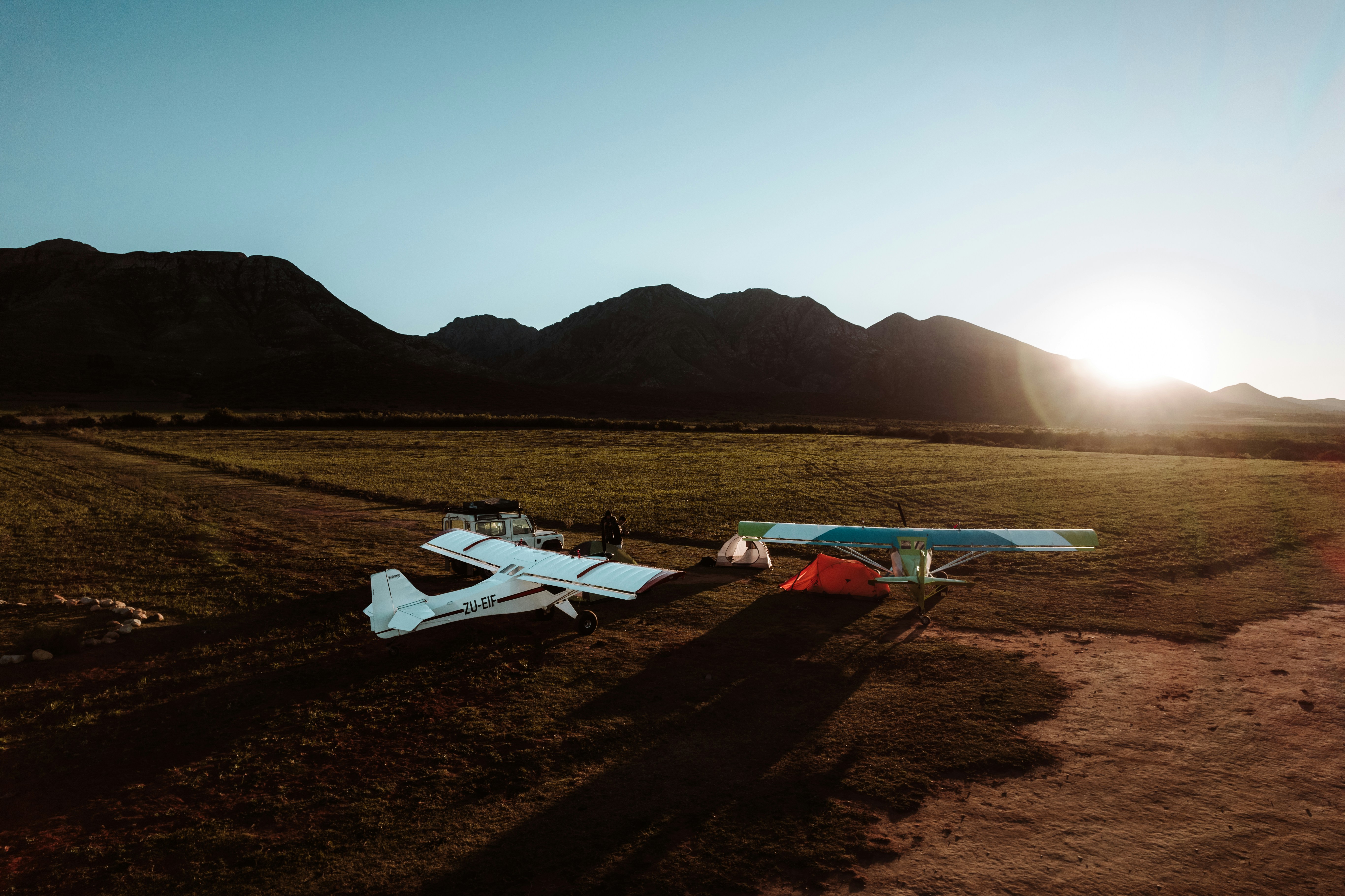 Light aircraft at sunset with mountains